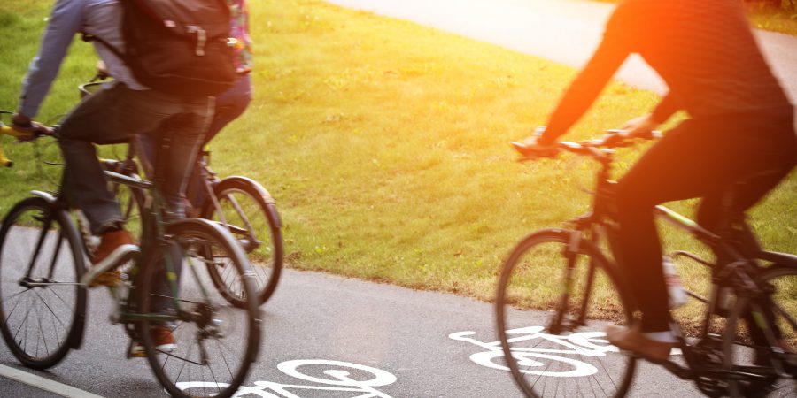 Tre personer cyklar på en cykelbana